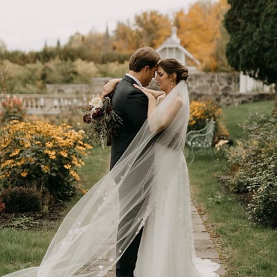 Couple de mariés s’enlaçant dans les jardins du Spa StoneHaven Le Manoir à Sainte-Agathe-des-Monts.